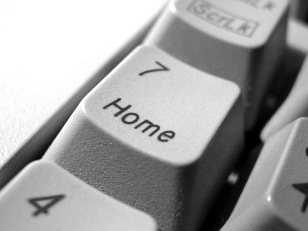 Close up photograph of a keyboard, focusing on the number seven key, which also includes the word 'home'.