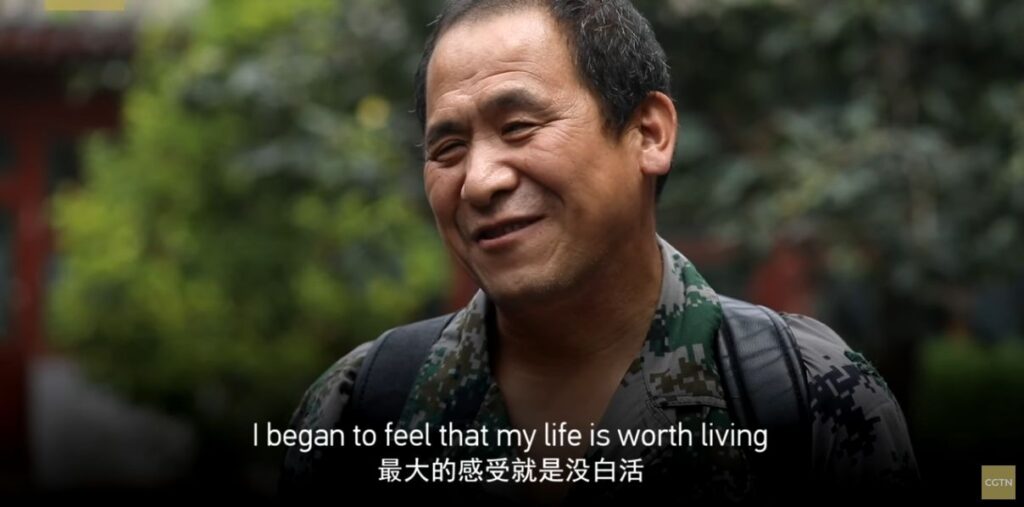 The vision-impaired man continues to speak to the camera, now smiling. Closed Caption translation: "I began to feel that my life is worth living.""